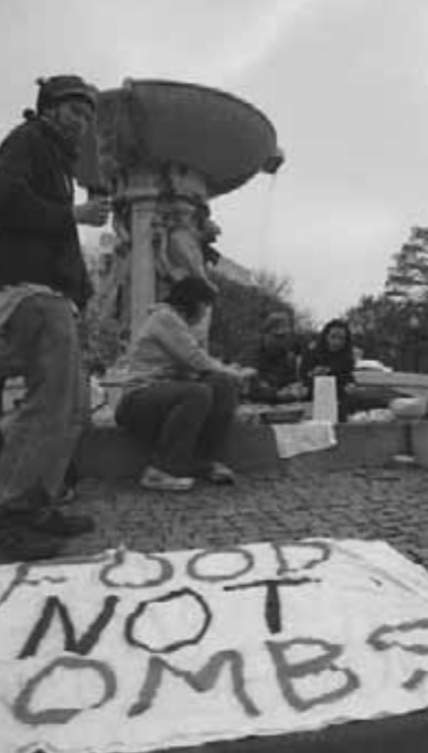 A photo of members of the Food Not Bombs organization eating at Dupont Circle.
