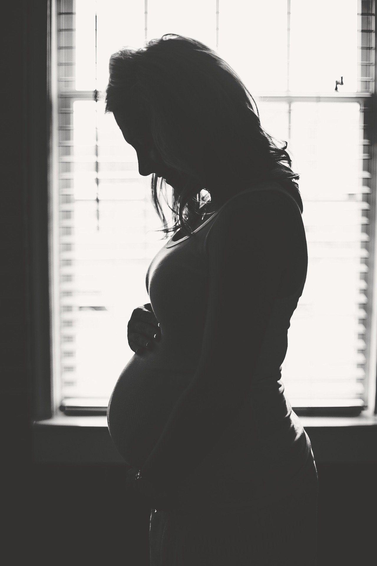 A silhouette of a pregnant woman.