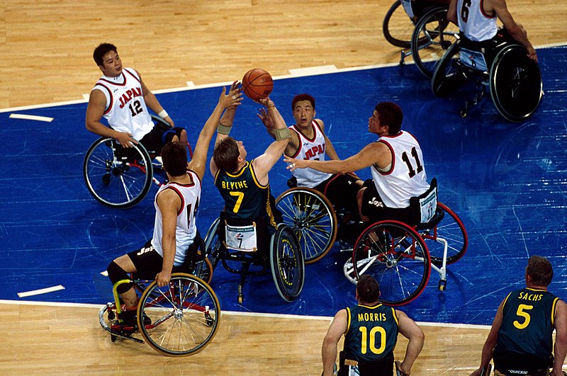 A group of men playing wheelchair basketball.