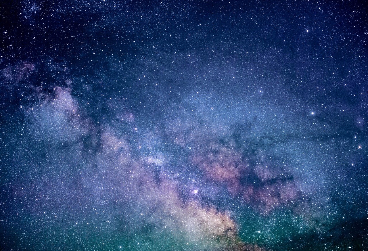 Photo of the stars at night; the Milky Way is visible.