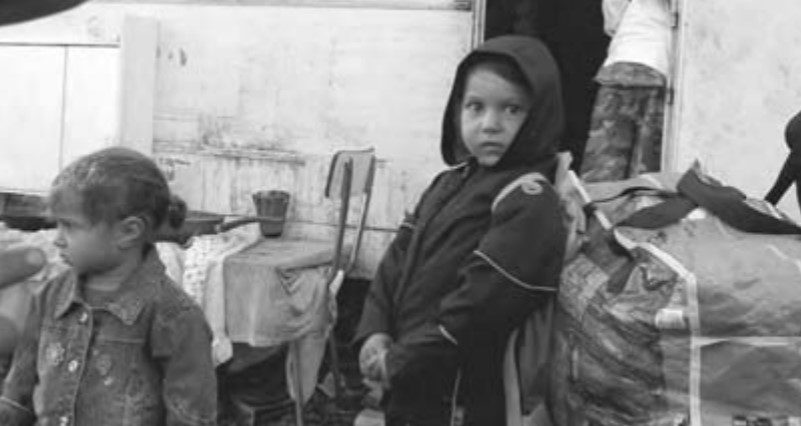 Photo of a Roma child looking directly into the camera.
