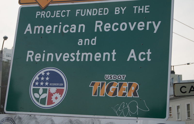 Photo of a infrastructure project that is part of the stimulus spending; it boldly states the name of the program and points to recovery.gov