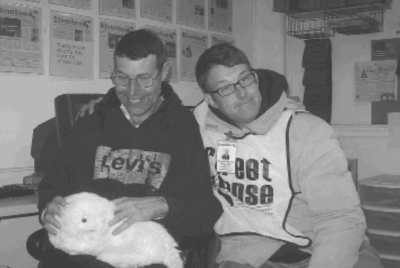 Photo of Orin and Ken posing together in the Street Sense Media office