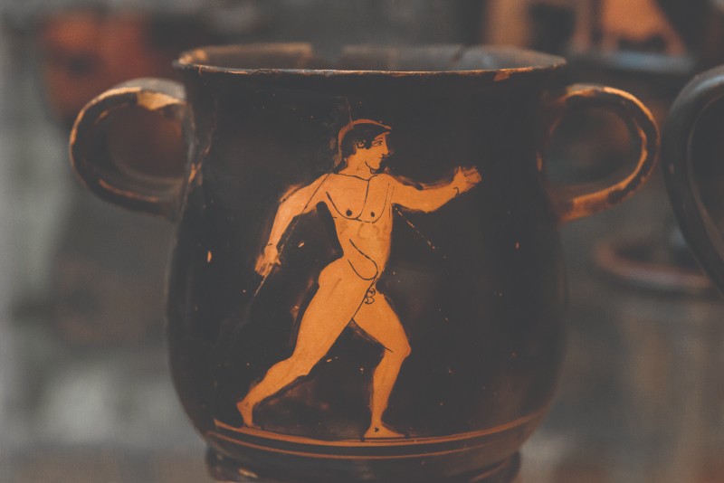 Photo of a vase with a walking man depicted