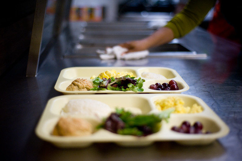 Photo of trays of breakfast sitting on a counter.