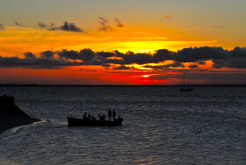 Photo of people in a large canoe off the coast of Mozambique