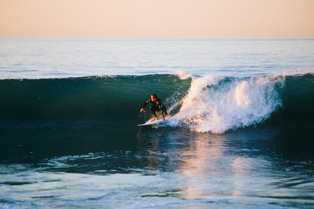 Photo of a person surfing in the ocean.