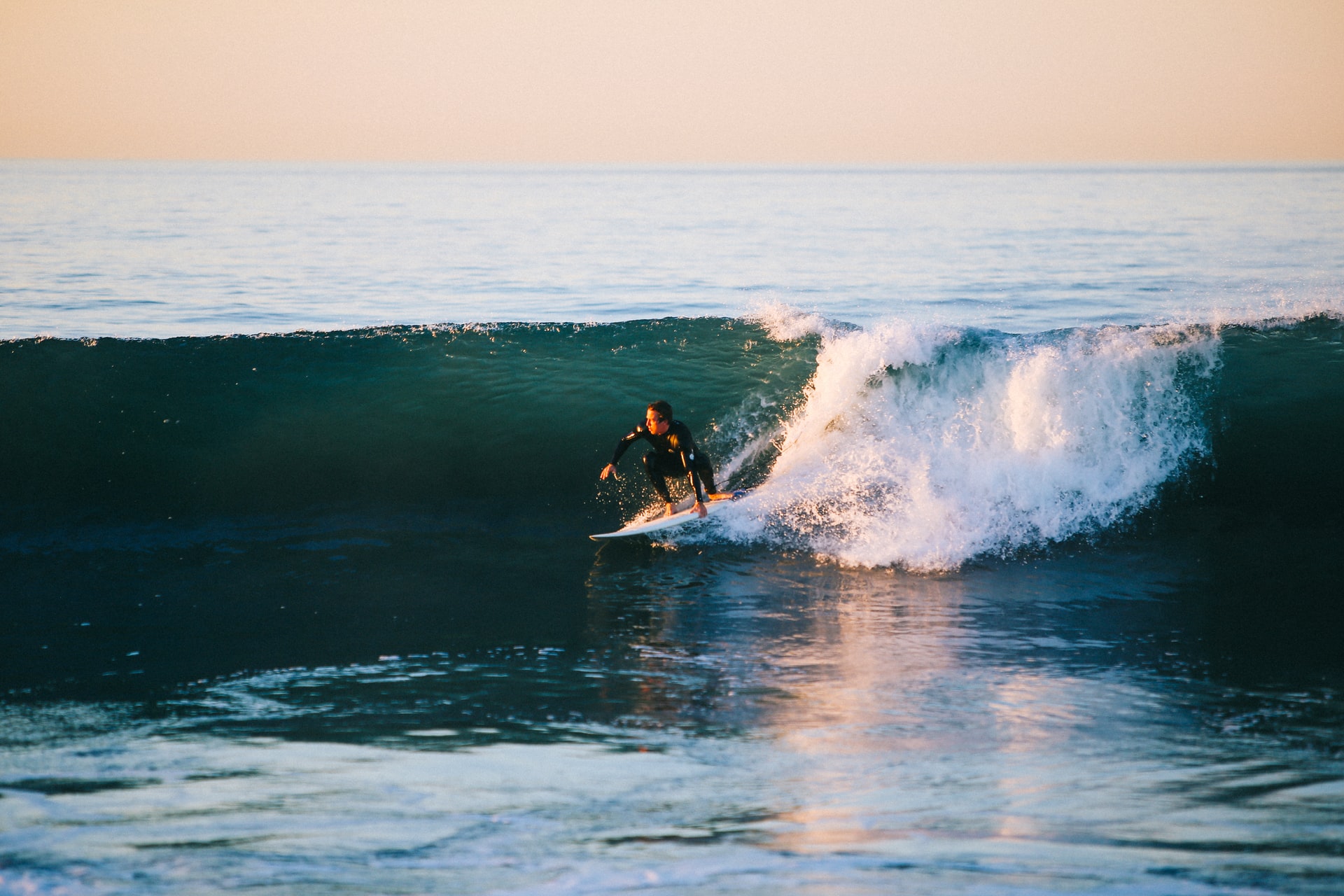 Photo of a person surfing in the ocean.