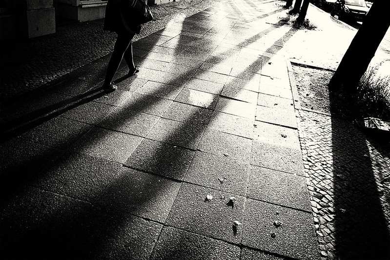 A black and white photo of a empty sidewalk