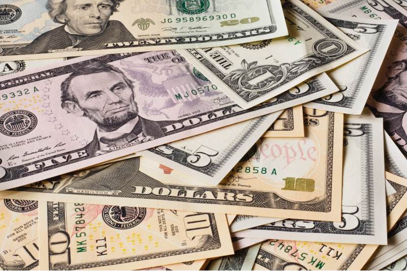 Photo of a pile of various dollar bills in various denominations