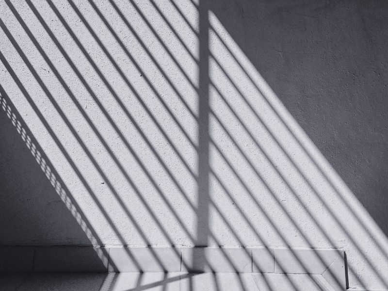 Photo of streaks of light running down a white wall