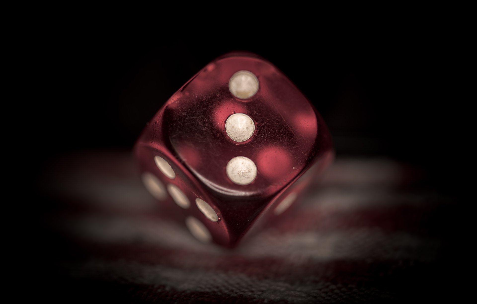 Photo of a dice showing the "three" side.