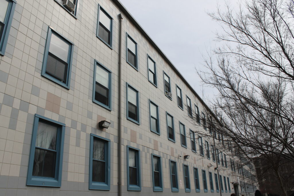 A white building with blue window frames on a bleak day.