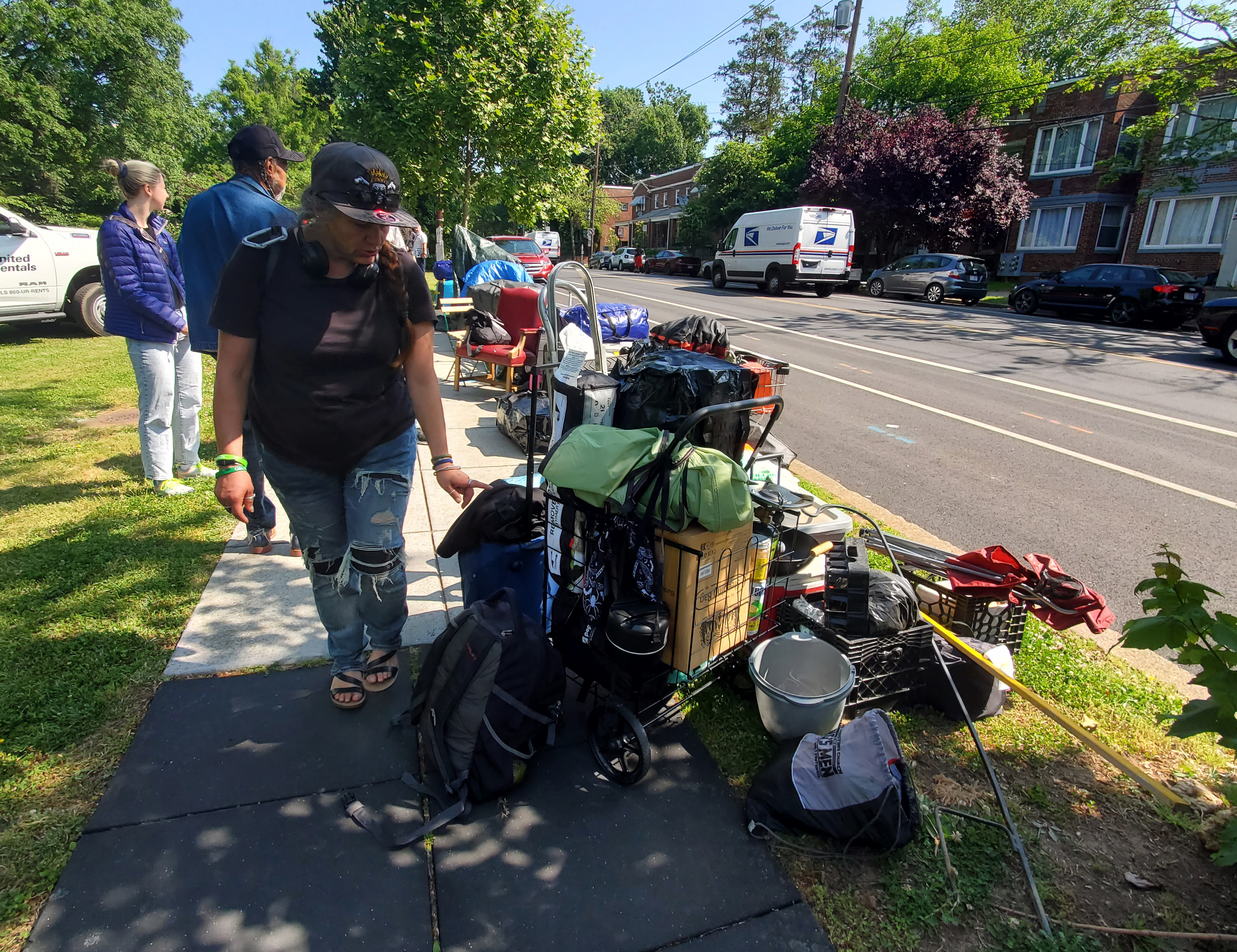 On May 25 at 10 a.m., Shelley Byars carried her belongings to the sidewalk while officials from the Office of the Deputy Mayor of Health and Human Services (DMHHS) cleared her encampments. Photo by Athiyah Azeem