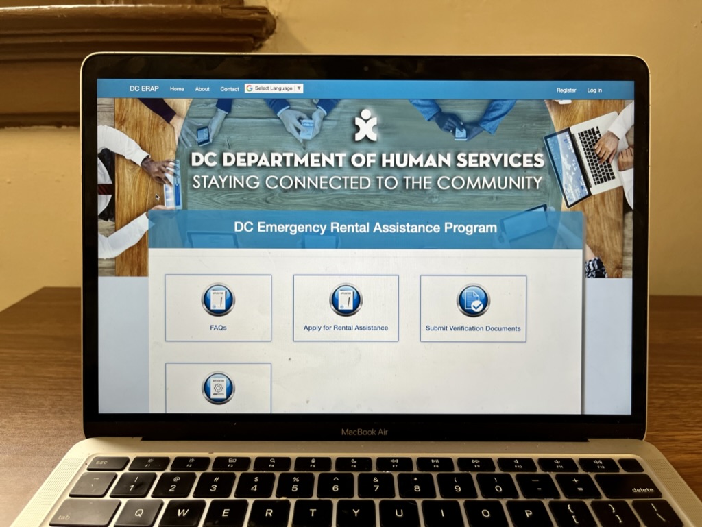 A laptop is open to the portal to apply for emergency rental assistance.