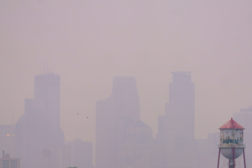 City buildings hidden behind smoke.