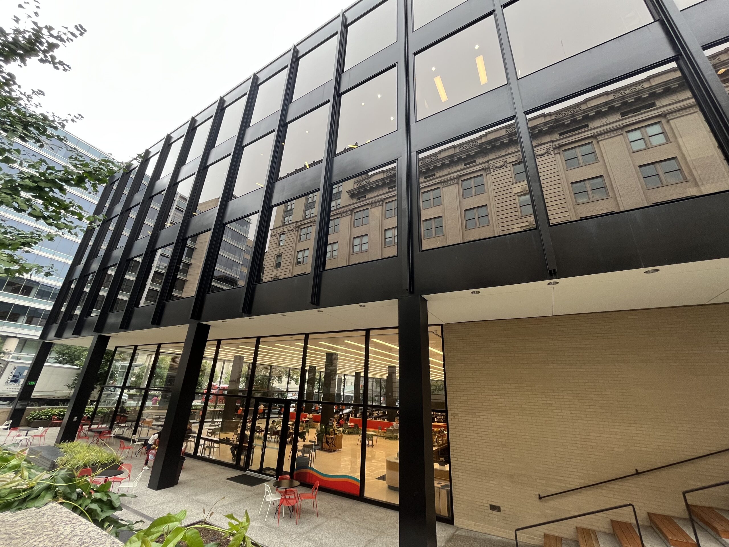 A large black building with floor to ceiling windows.