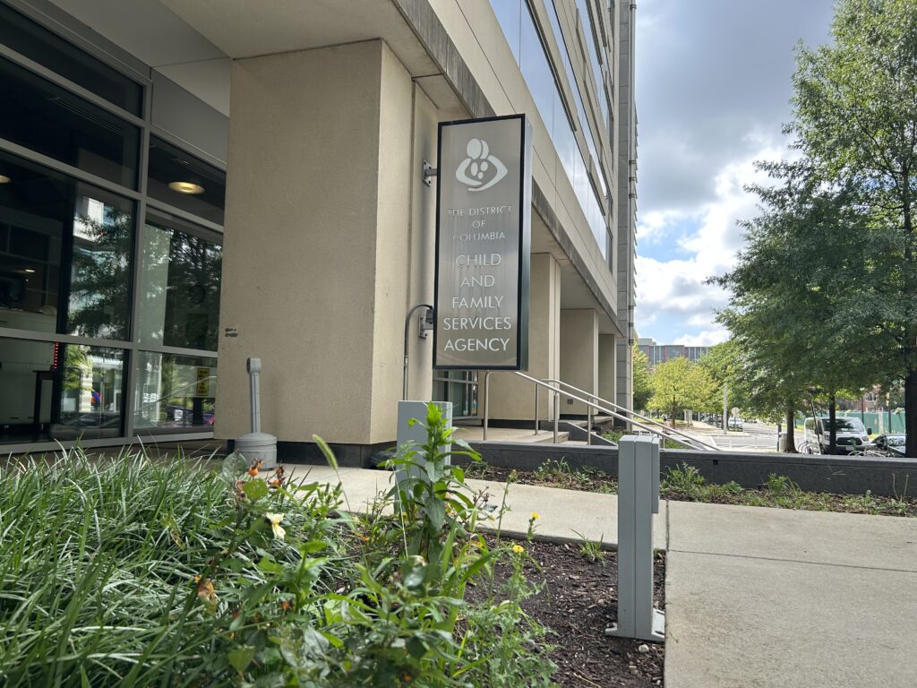 A silver sign on the side of a building reads "Child and Family Services Agency."