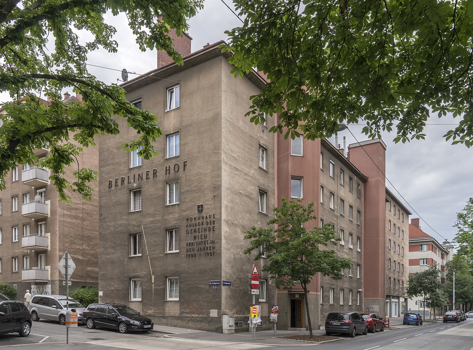 The corner of a brown apartment building.