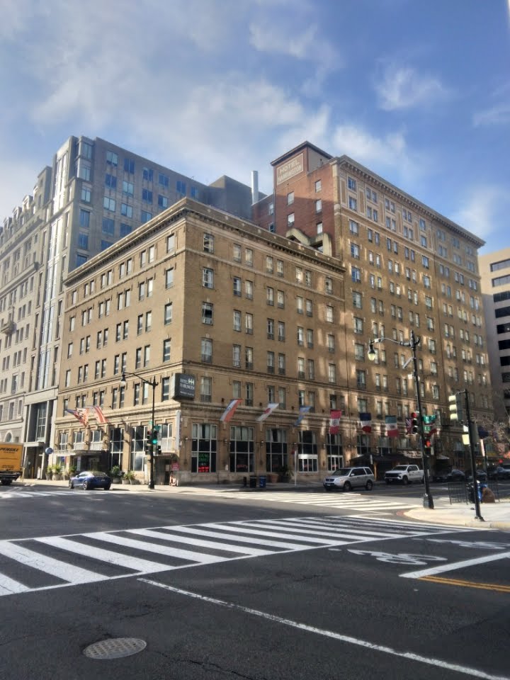 A brown building with windows against a blue sky.