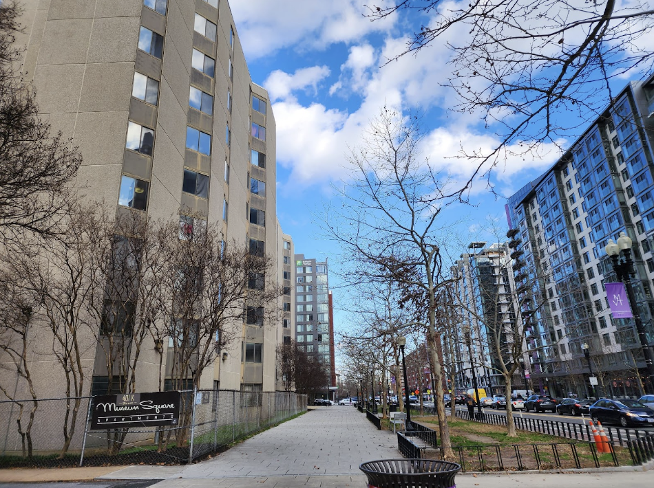 Two buildings across from each other with trees in the middle.
