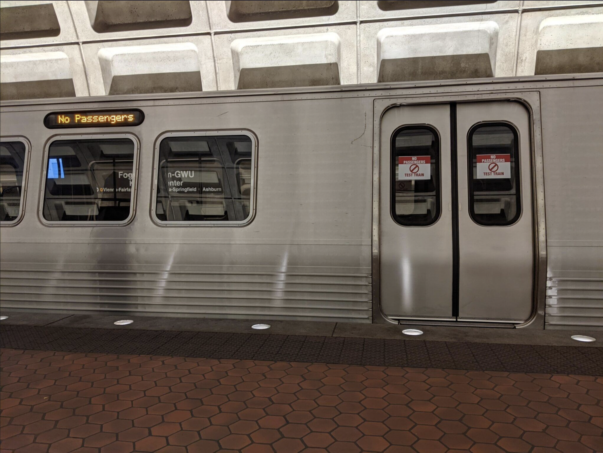 A train stopped at the Foggy Bottom Metro stop.