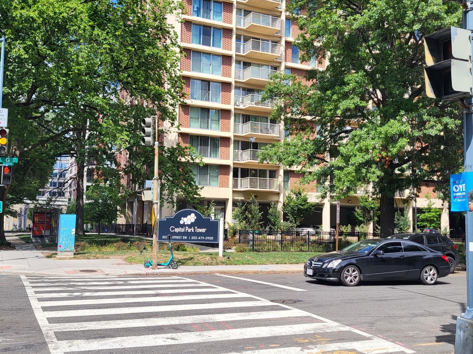 An apartment building between two trees.