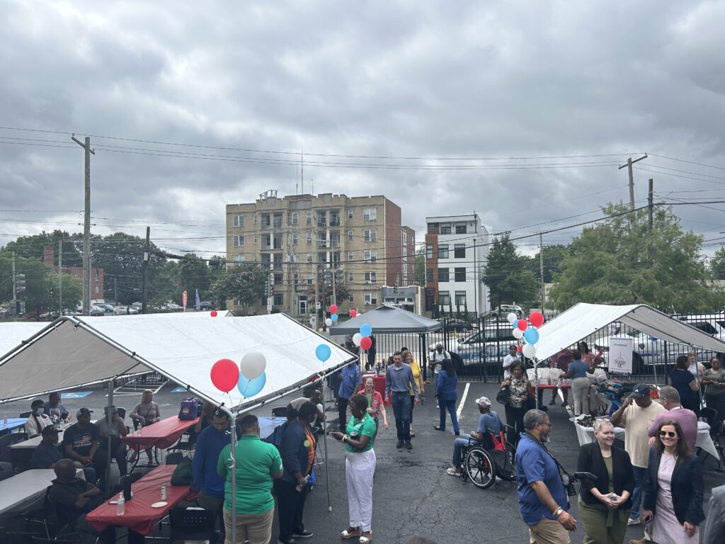A photo showing tents, balloons, and people walking around at the veteran surge event.