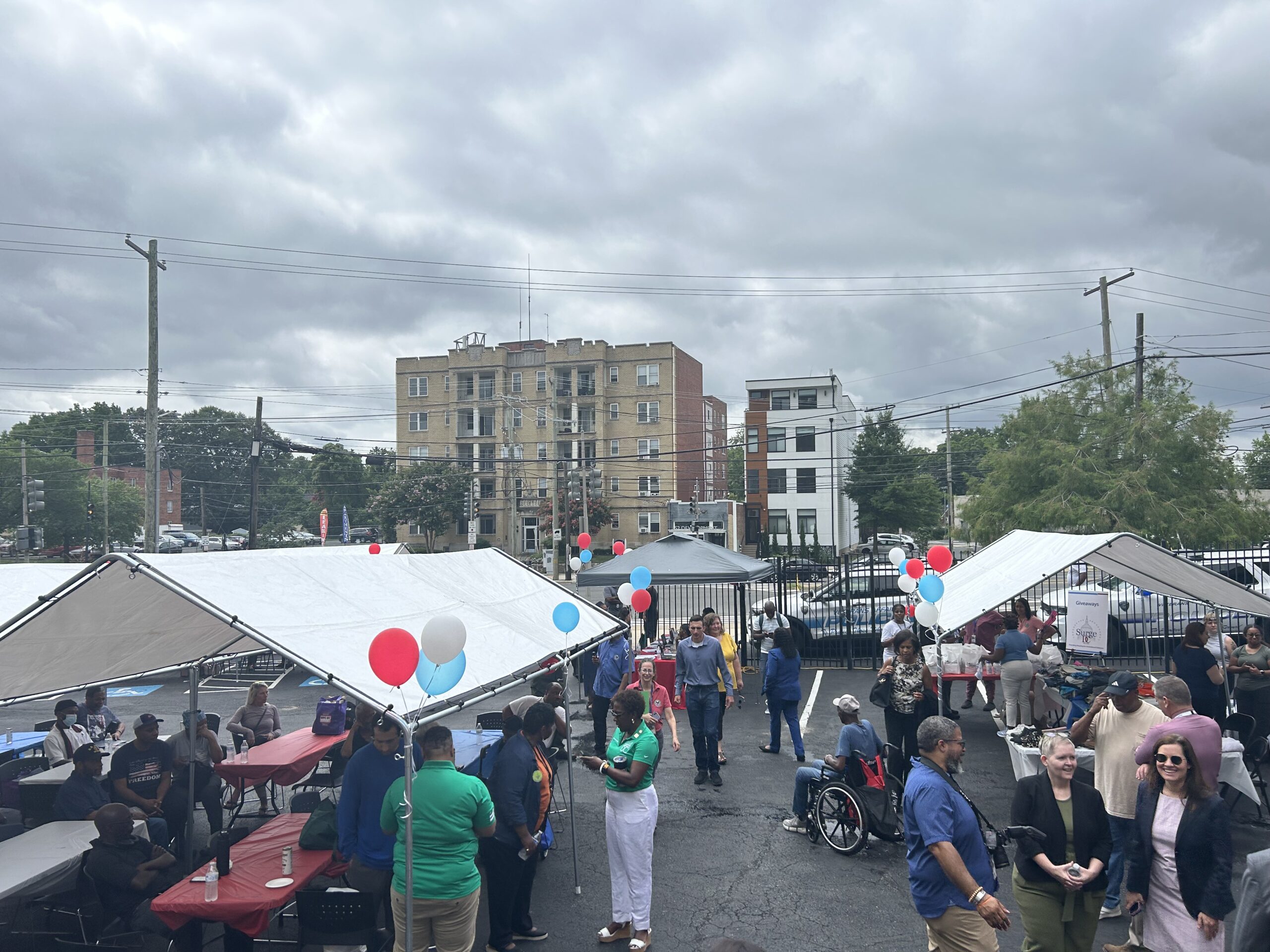 A photo showing tents, balloons, and people walking around at the veteran surge event.