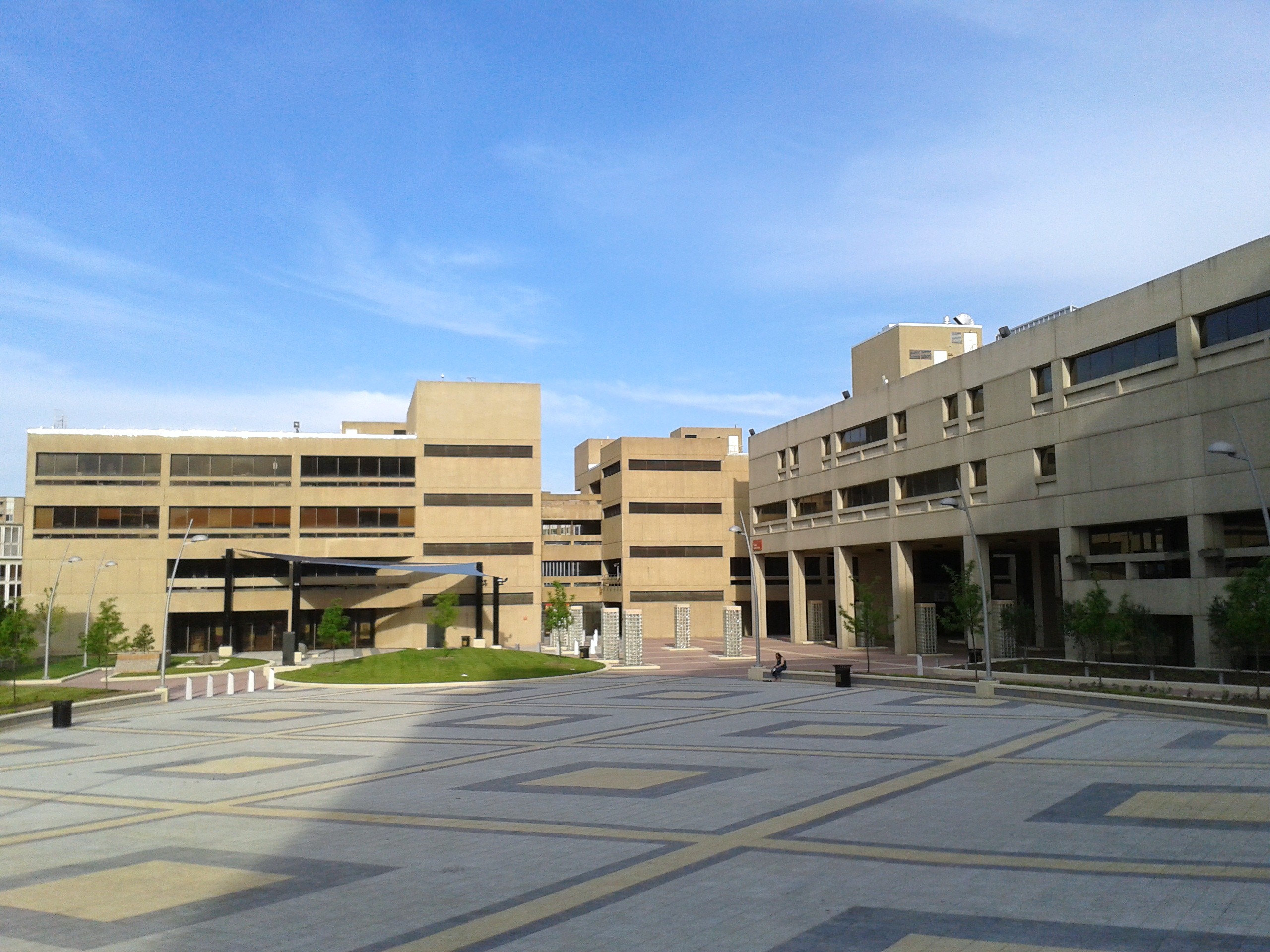 Two beige buildings around a sqaure.